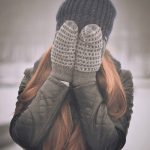 girl covering face with hands